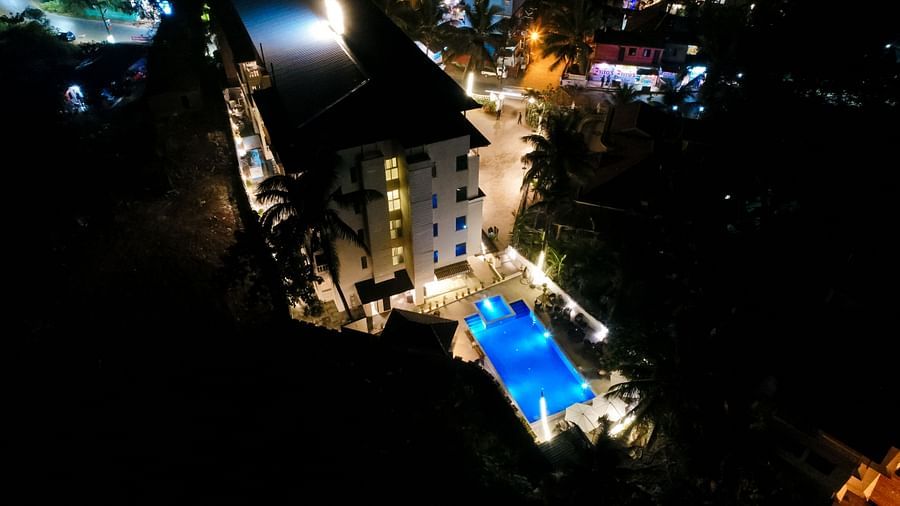 Aerial view of Calux Grand Baga at night with a swimming pool in front.